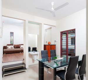 Dining Room : The Living Room is also visible, Ambient lighting is given on the top of wash basin.