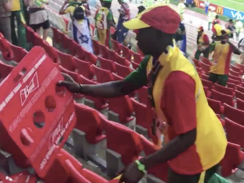Senegal fans cleaning up the stadium